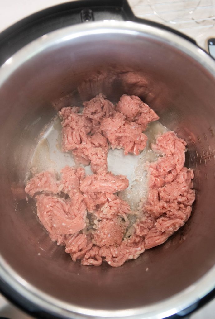 ground chicken being sauteed in the Instant Pot 