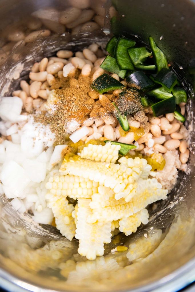 vegetables and beans added to the inner pot of an Instant Pot