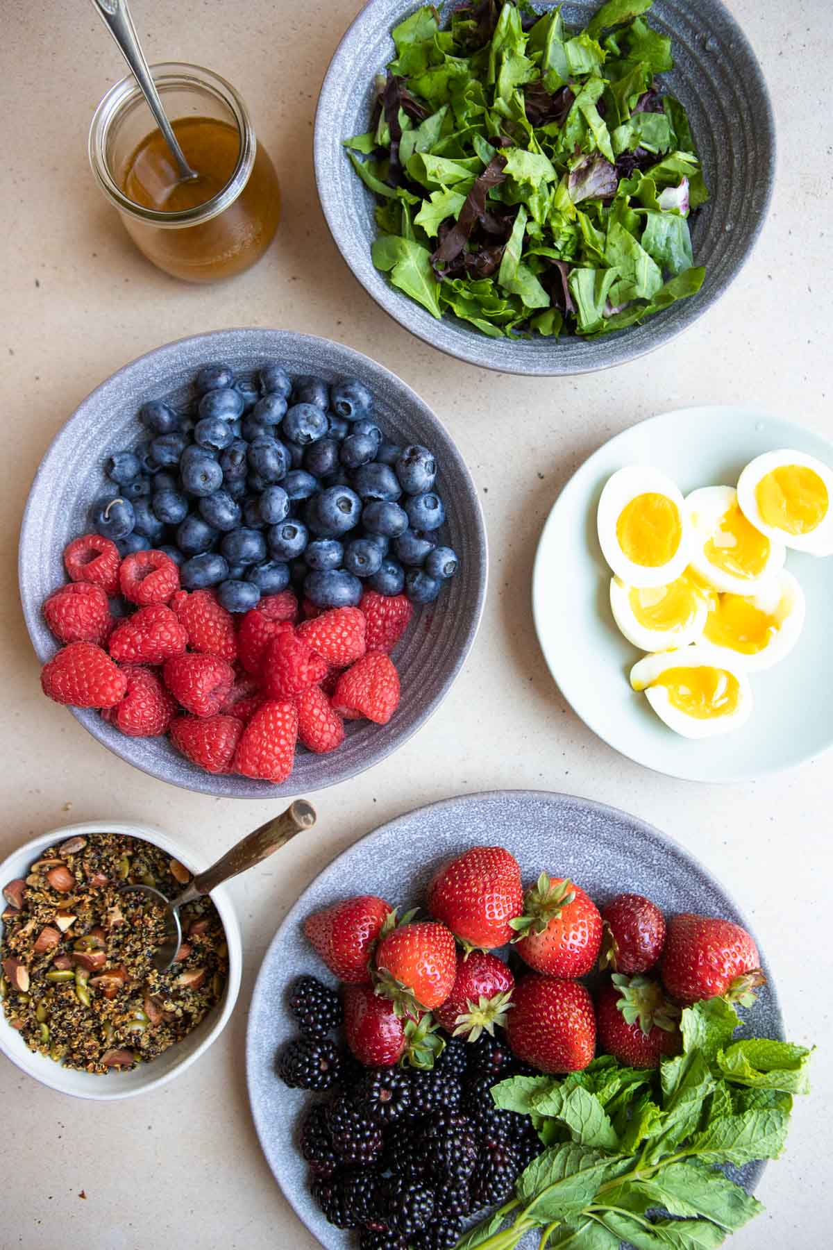 ingredients to make a breakfast fruit salad with berries and soft-boiled eggs