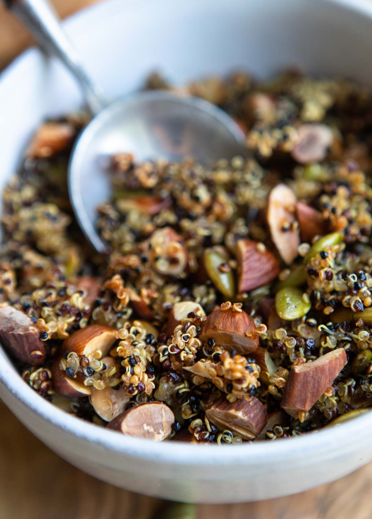 nutty crispy quinoa spooned out of a ceramic bowl