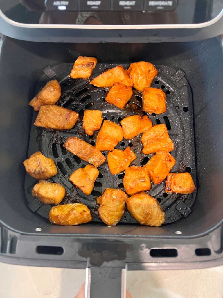 air fryer teriyaki salmon being cooked in an air fryer