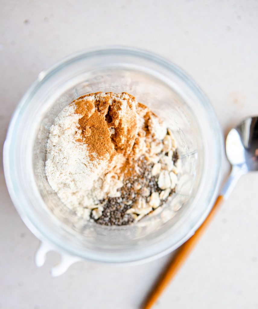 oats, chia seeds, pumpkin protein powder and pumpkin pie spice in a mason jar