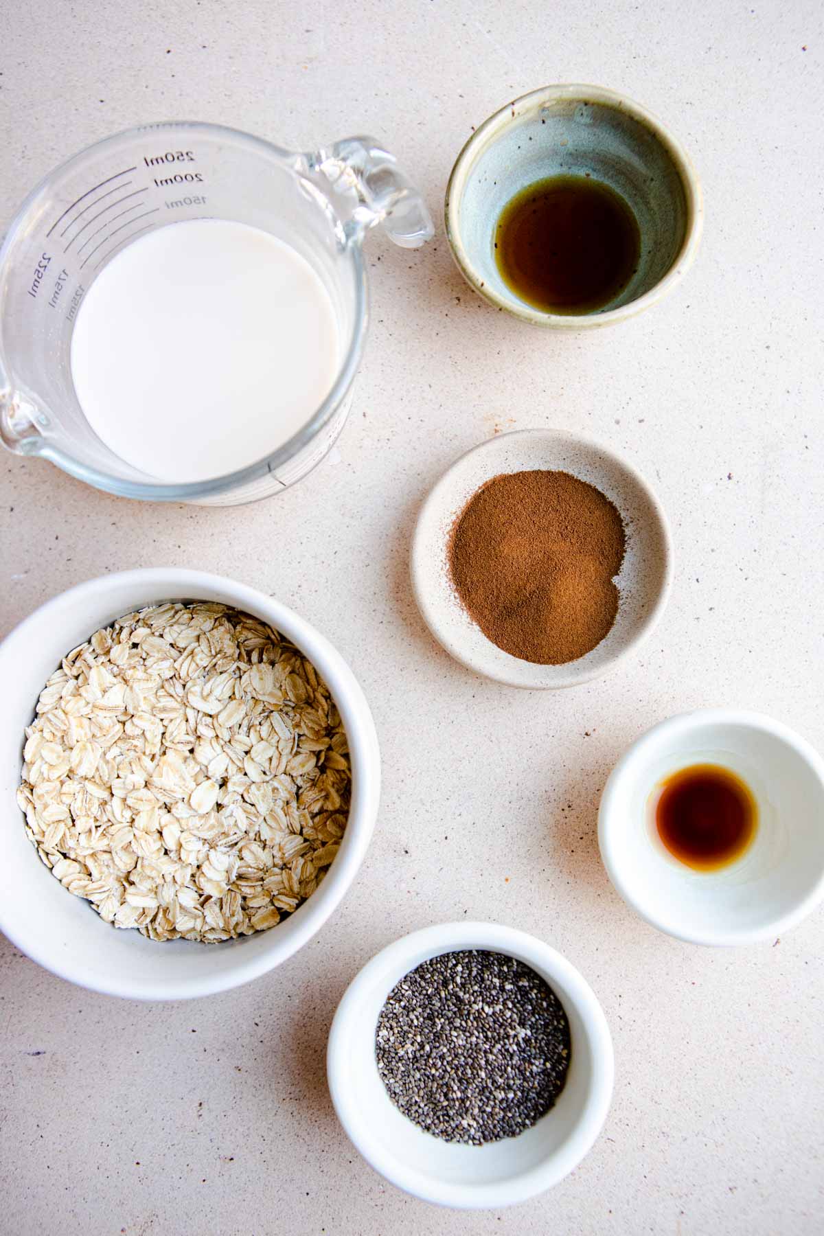 ingredients in white bowls to make coffee overnight oats