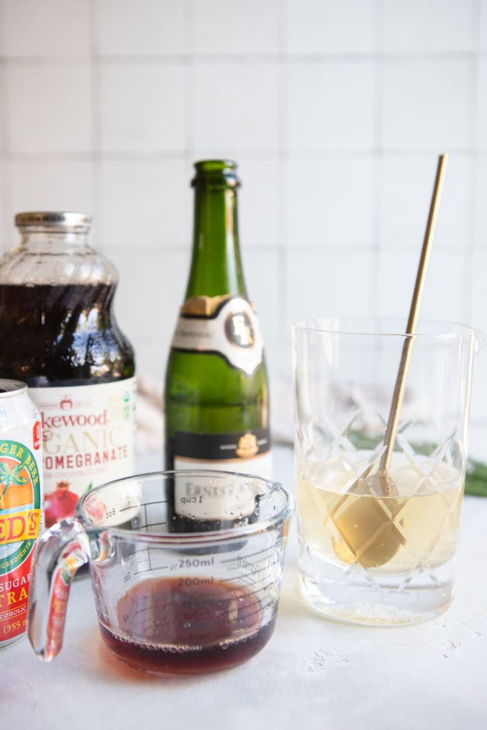 champagne and ginger beer in a mixing glass