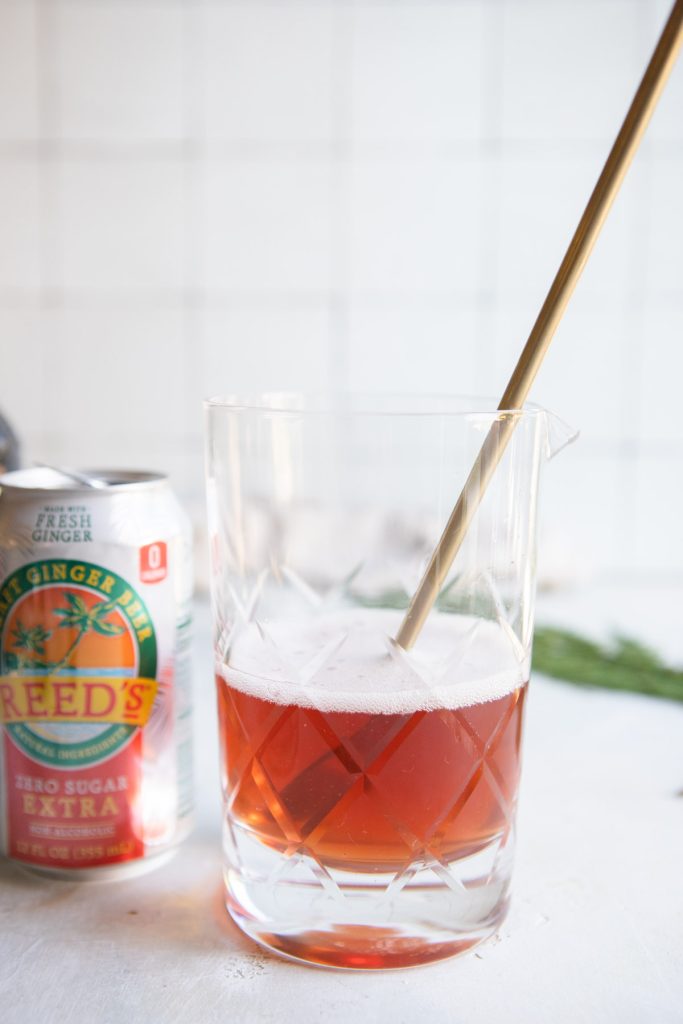 pomegranate champagne spritz in a mixing glass