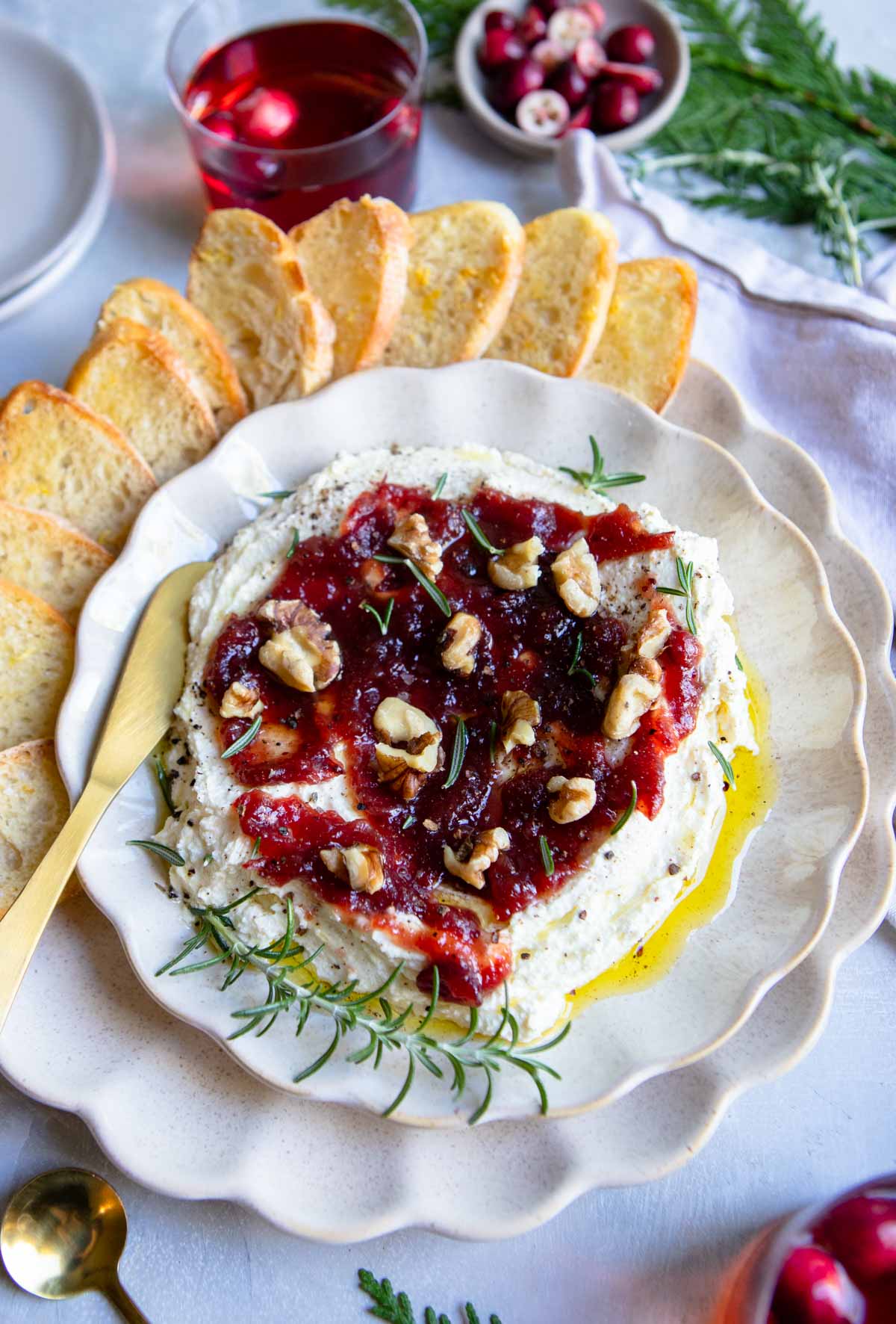 cranberry whipped feta dip on a platter with crostini