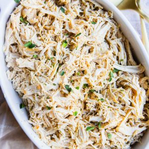 dutch oven shredded chicken served in a ceramic platter