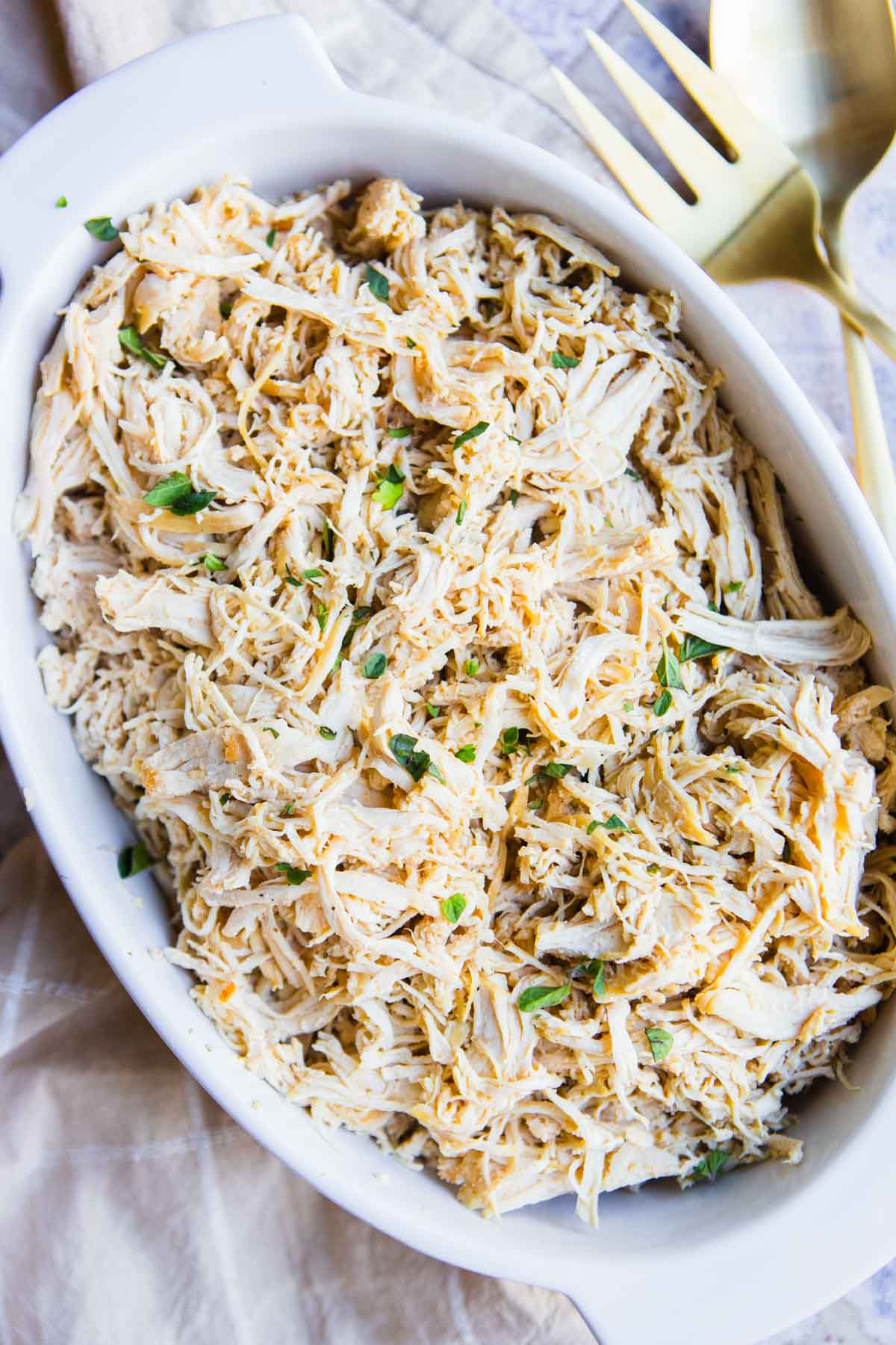 dutch oven shredded chicken served in a ceramic platter