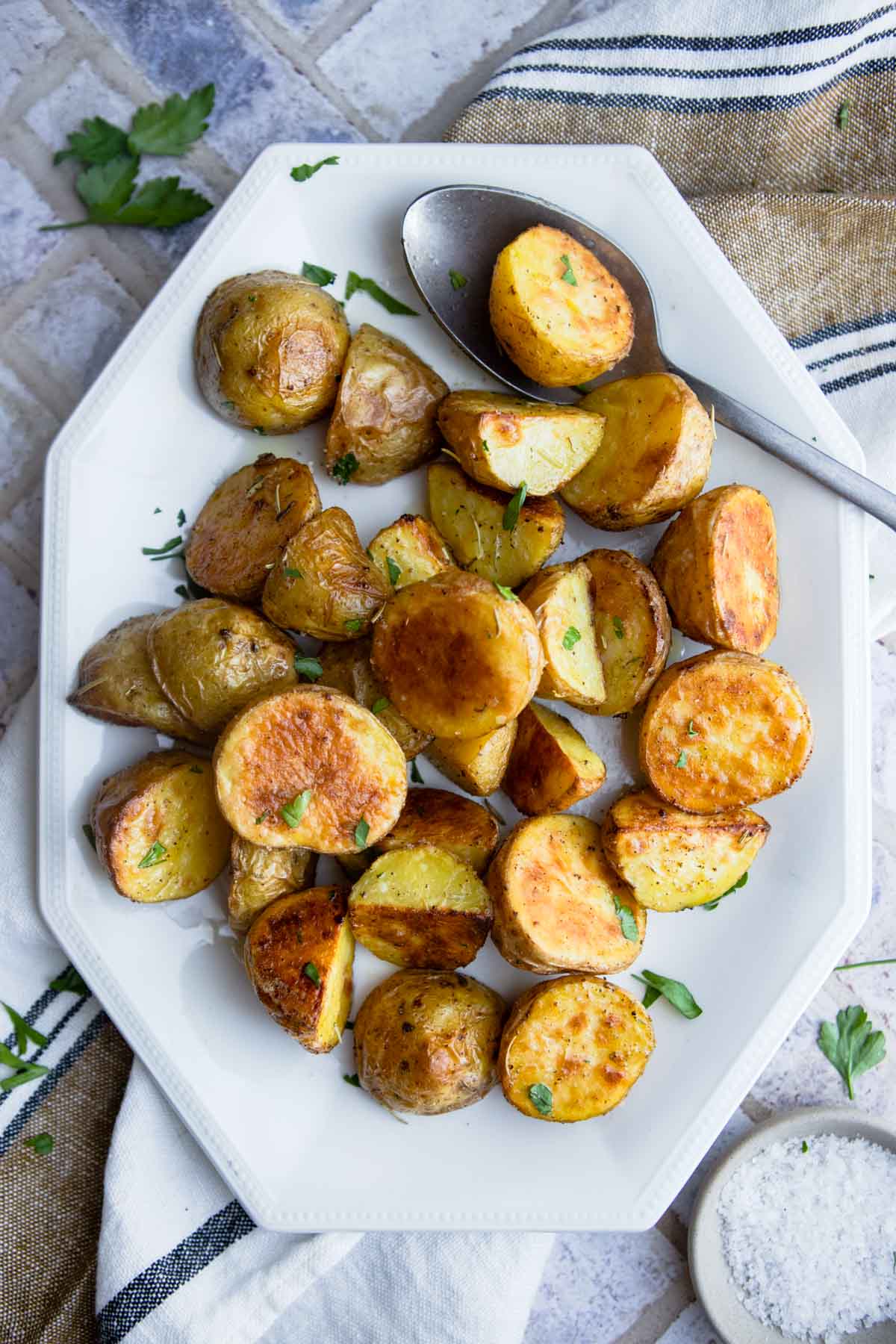 baby dutch yellow potatoes roasted and plated on a white ceramic plate