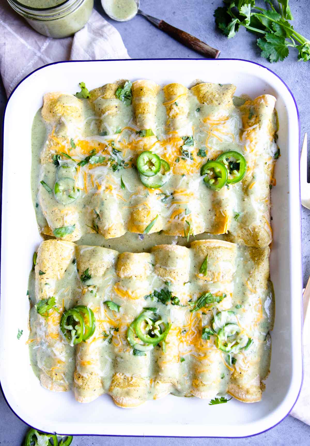 baked tray of green chili chicken enchiladas 