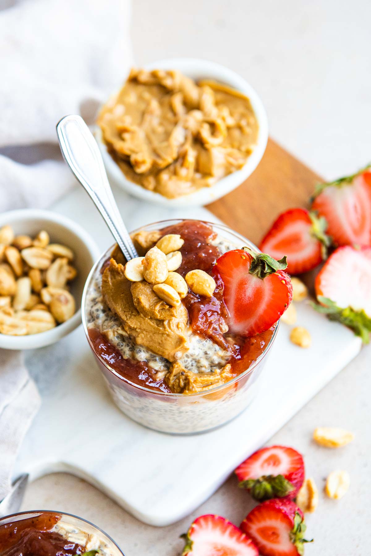 peanut butter and jam overnight oats topped with fresh strawberries and peanuts