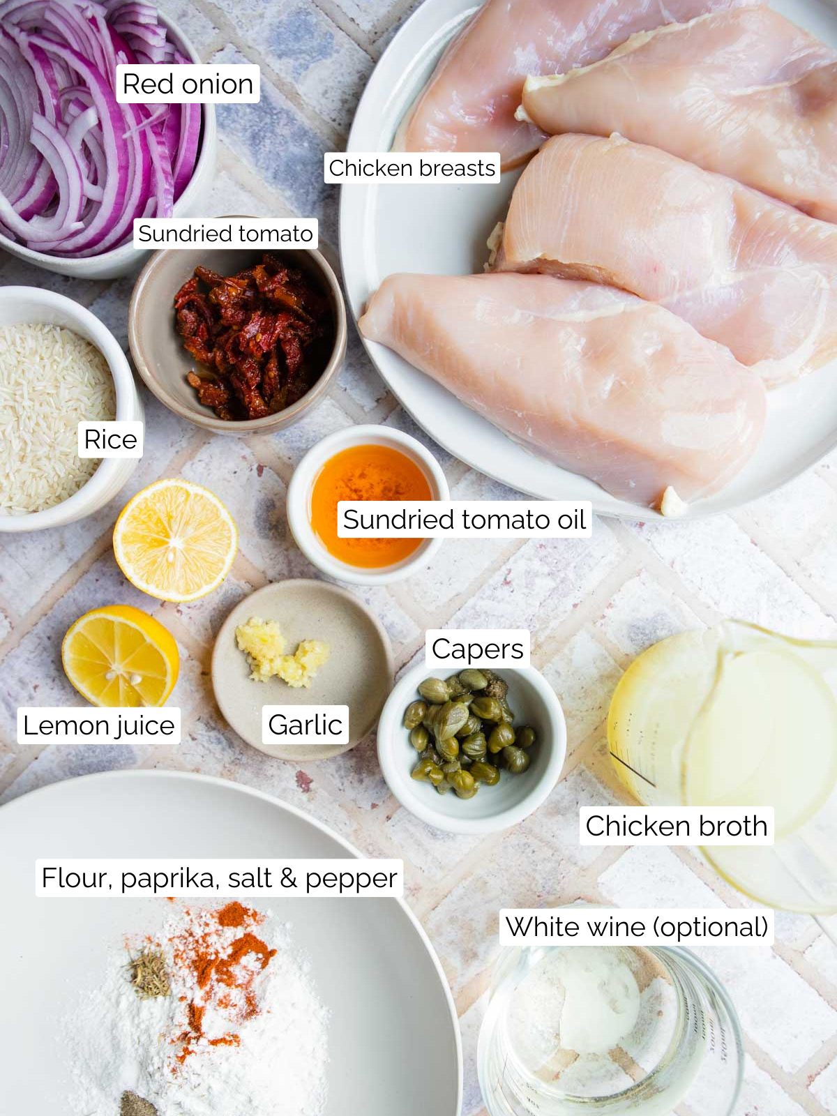 raw chicken breasts, fresh onions, sundried tomatoes and other ingredients to make a one pan chicken and rice dish