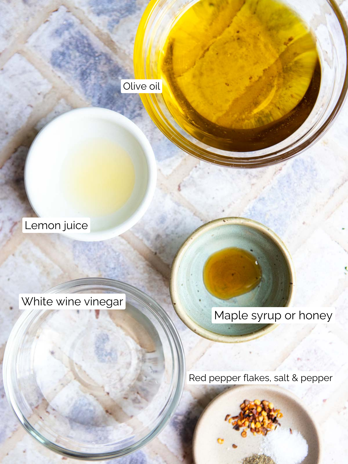 ingredients to make a lemon vinaigrette in small glass bowls