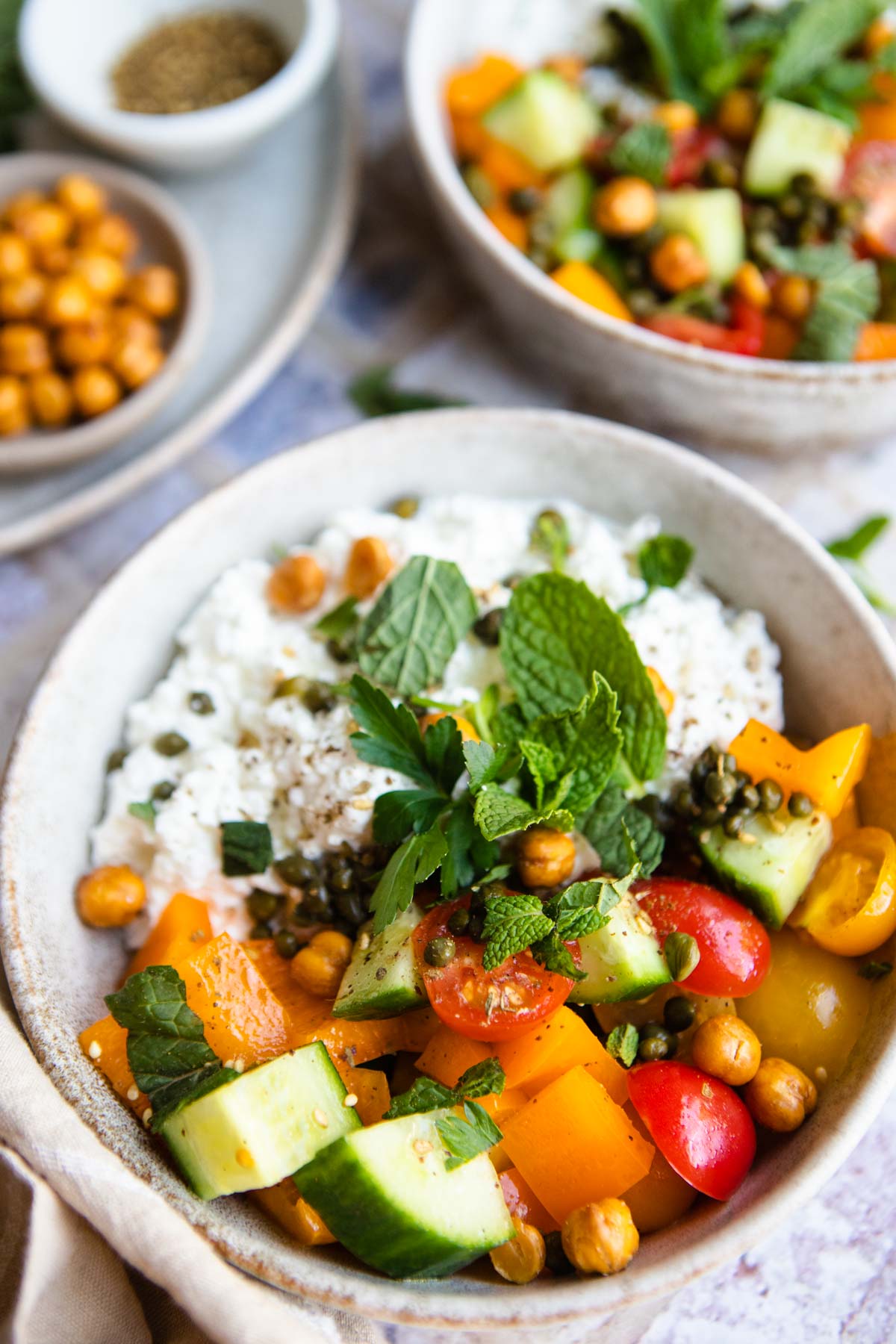 savory cottage cheese bowl with veggies, fresh herbs and crunchy chickpeas