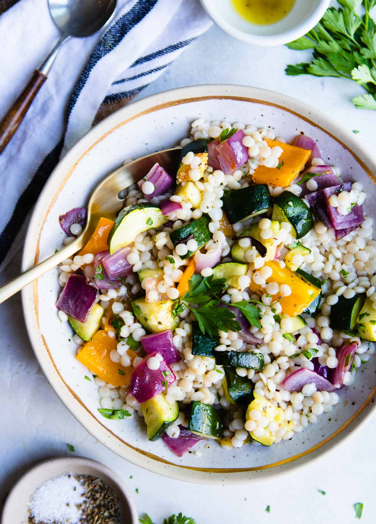 couscous salad with vegetables on a beige plate