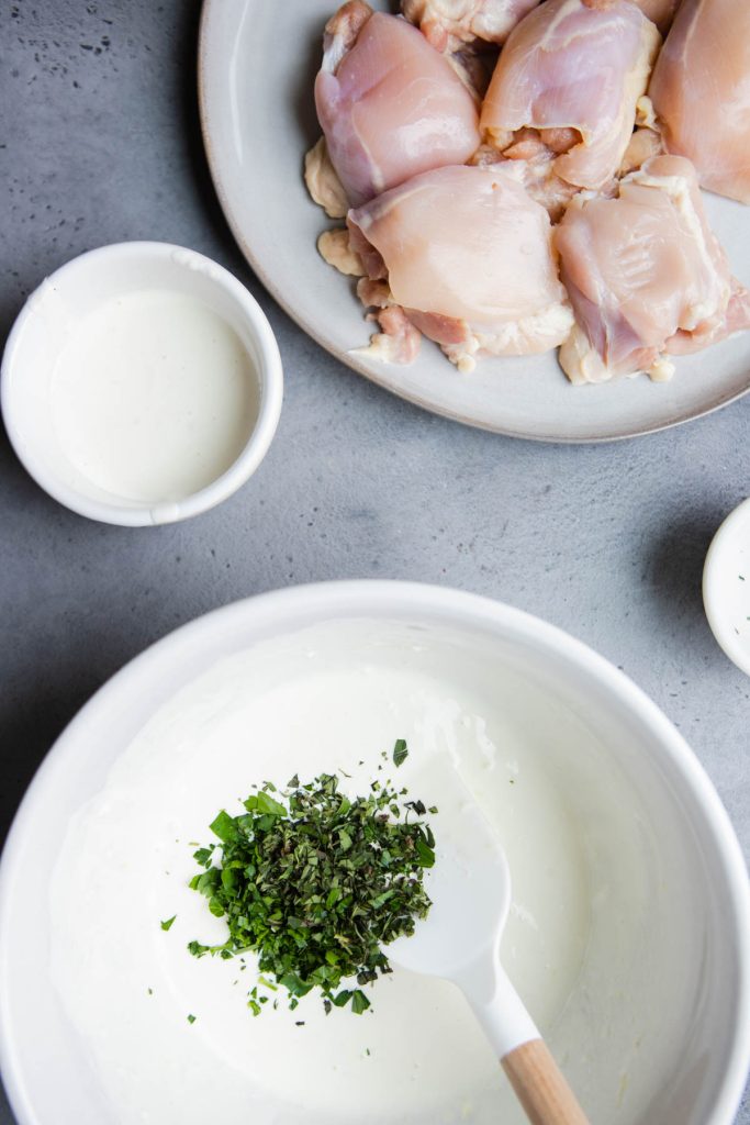 fresh herbs added to a chicken marinade using Greek yogurt