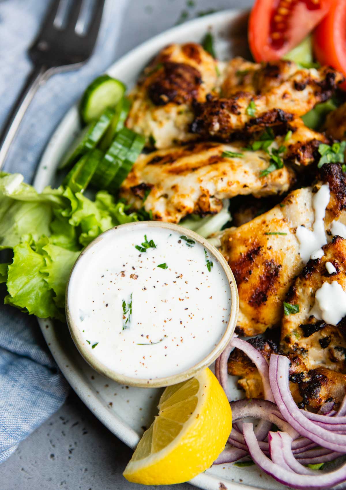 lemon garlic Greek yogurt sauce served alongside grilled chicken thighs